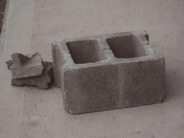 A block of concrete with two pieces broken off.